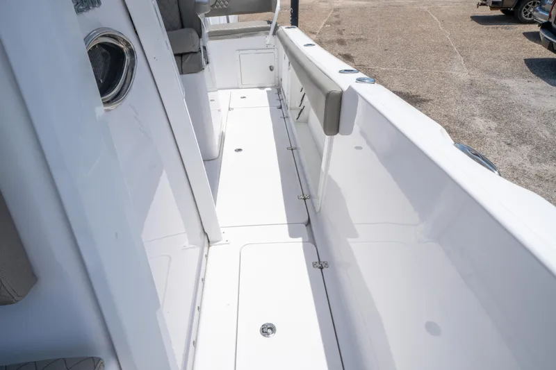 Slide: The Image of 2024 Savannah 2900 Offshore boat interior with white deck and seating area. - 16