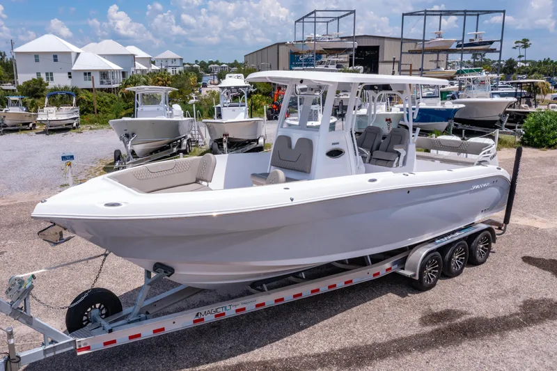 Slide: The Image of 2024 Savannah 2900 Offshore boat on trailer, displayed outdoors at a marina. - 2