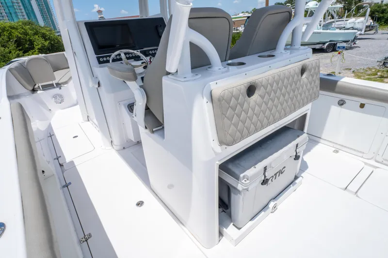 Slide: The Image of 2024 Savannah 2900 Offshore boat interior with helm, seating, and storage. - 9