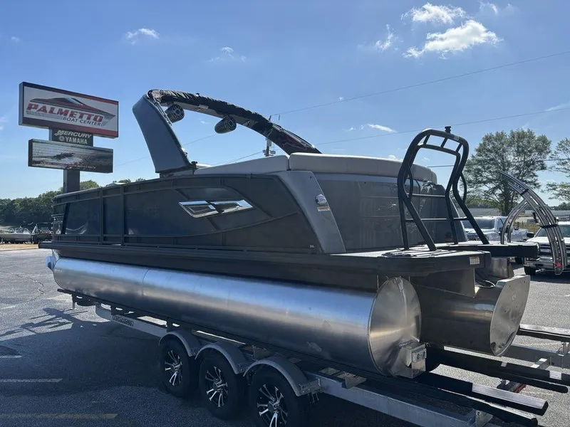 Slide: The Image of 2026 Godfrey AquaPatio 255 ULC pontoon boat on trailer at dealership. - 11