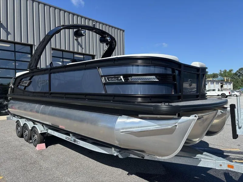 Slide: The Image of 2026 Godfrey AquaPatio 255 ULC pontoon boat on trailer, parked outdoors. - 12