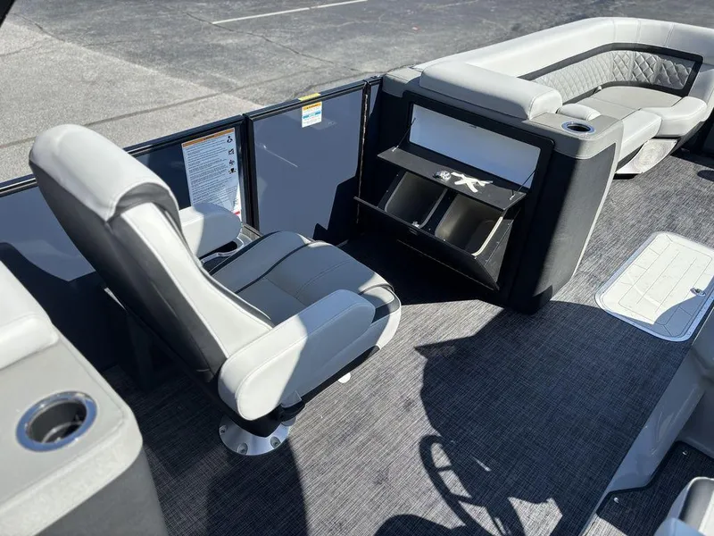 Slide: The Image of 2026 Godfrey AquaPatio 255 ULC boat interior with seating and storage compartments. - 17