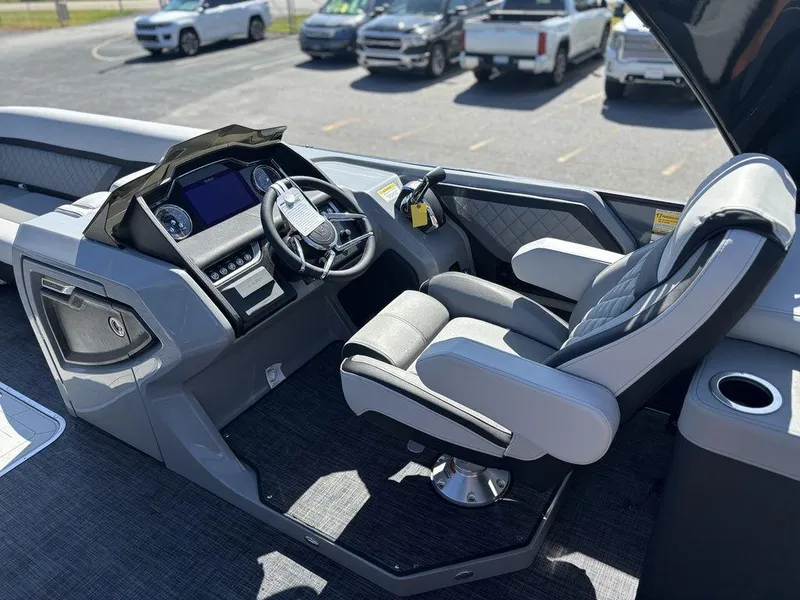 Slide: The Image of 2026 Godfrey AquaPatio 255 ULC boat interior with modern helm and luxurious seating. - 19