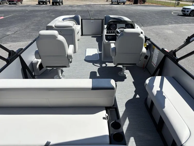 Slide: The Image of 2026 Godfrey AquaPatio 255 ULC pontoon boat interior with modern seating and helm. - 25