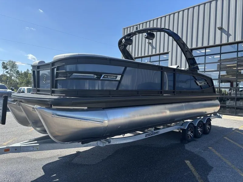 Slide: The Image of 2026 Godfrey AquaPatio 255 ULC pontoon boat on trailer, parked outdoors. - 3