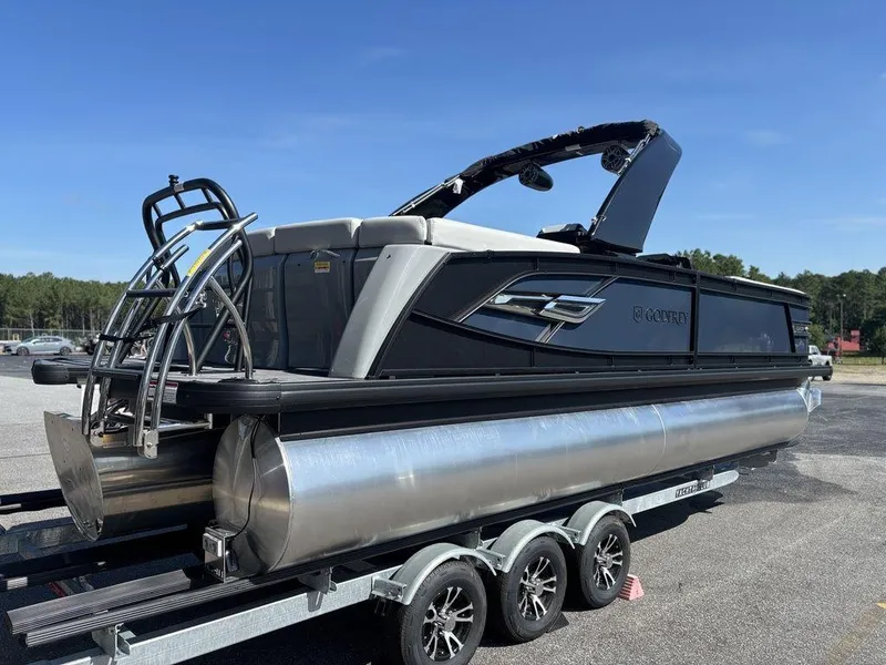 Slide: The Image of 2026 Godfrey AquaPatio 255 ULC pontoon boat on trailer, parked outdoors. - 5