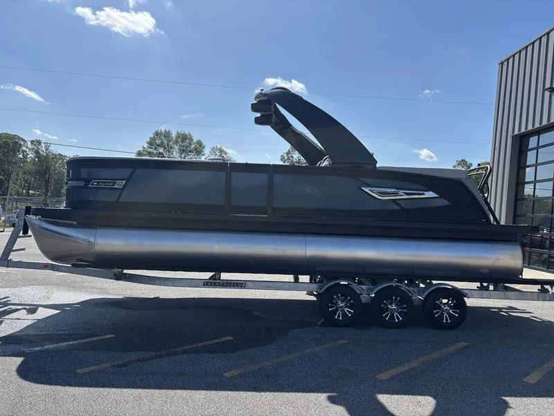 Slide: The Image of 2026 Godfrey AquaPatio 255 ULC pontoon boat on trailer, parked outdoors. - 7