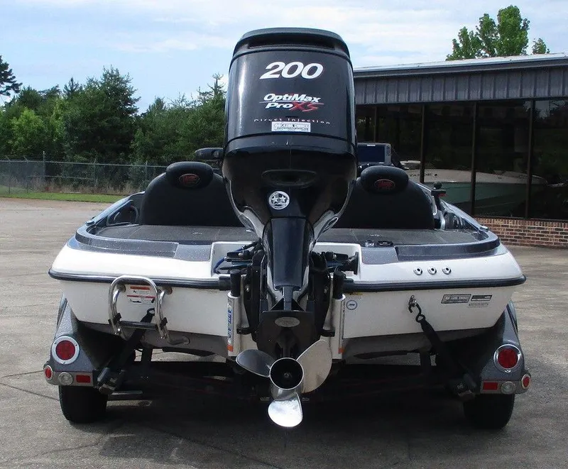 Slide: The Image of 2012 Ranger Z518 boat with OptiMax Pro XS engine, parked outdoors. - 3