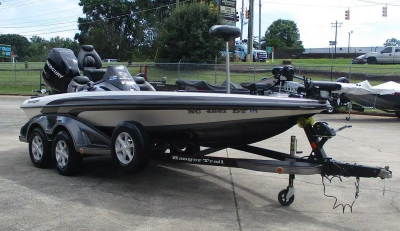 Slide: The Image of 2012 Ranger Z518 boat on trailer, parked outdoors, featuring a sleek design and powerful engine. - 4