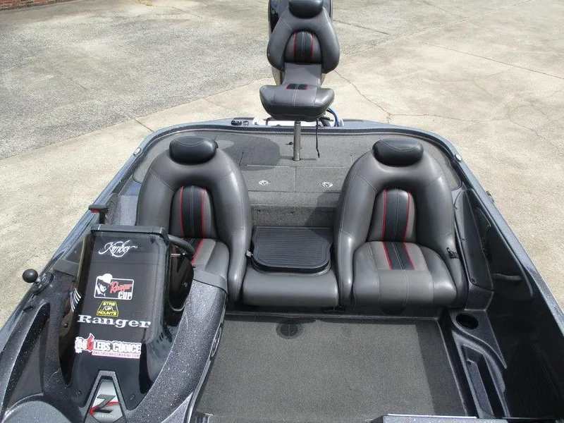 Slide: The Image of 2012 Ranger Z518 boat interior with gray leather seats and dashboard stickers. - 6