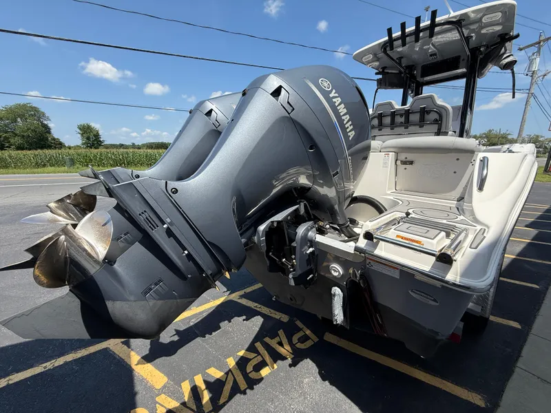 Slide: The Image of 2022 NauticStar 2602 Legacy boat with Yamaha outboard motor, parked on a sunny day. - 11