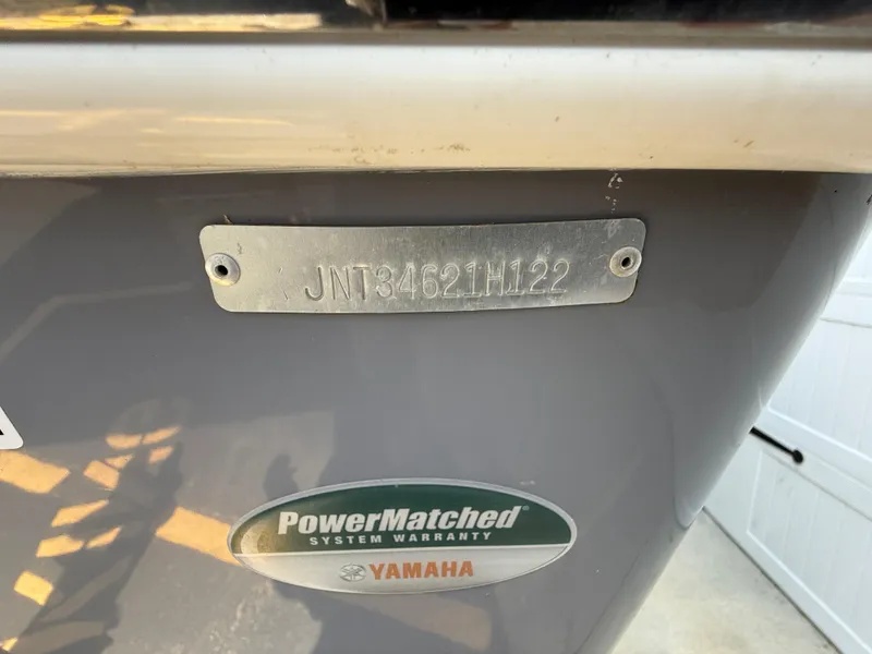 Slide: The Image of 2022 NauticStar 2602 Legacy boat hull identification number and Yamaha warranty sticker. - 13