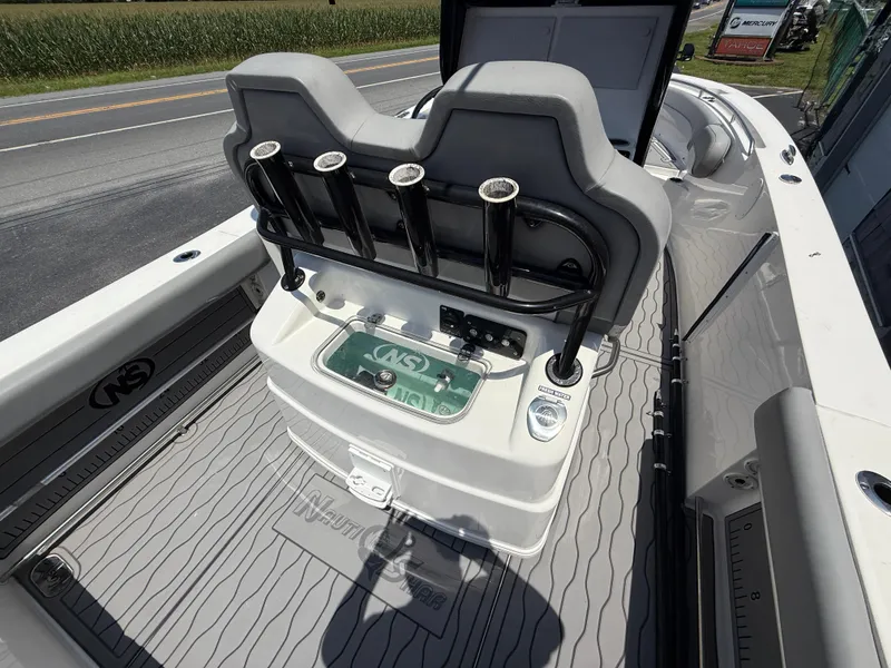 Slide: The Image of 2022 NauticStar 2602 Legacy boat interior with rod holders and storage compartments. - 16