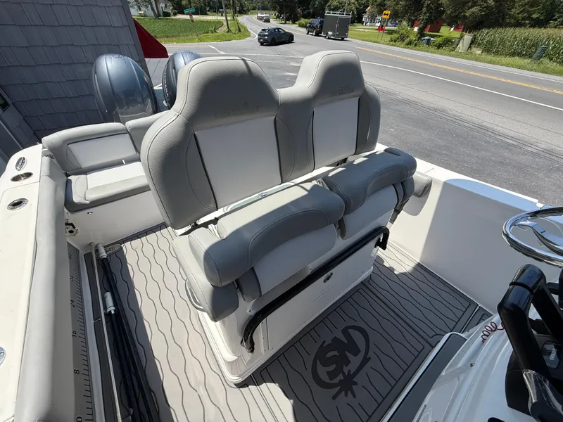 Slide: The Image of 2022 NauticStar 2602 Legacy boat interior with dual seats and modern design. - 23