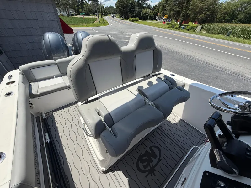 Slide: The Image of 2022 NauticStar 2602 Legacy boat interior with dual seats and steering wheel. - 24