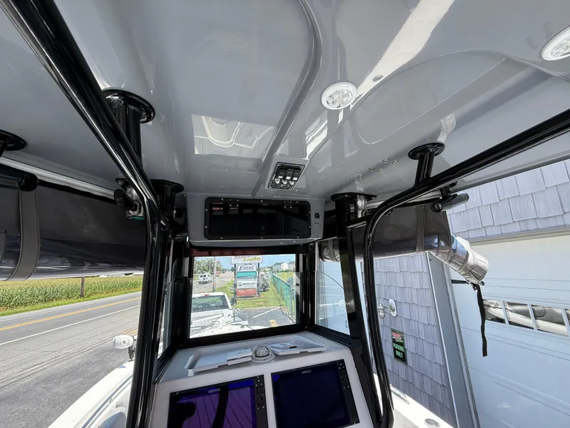 Slide: The Image of Interior view of 2022 NauticStar 2602 Legacy boat cockpit with modern controls and displays. - 27