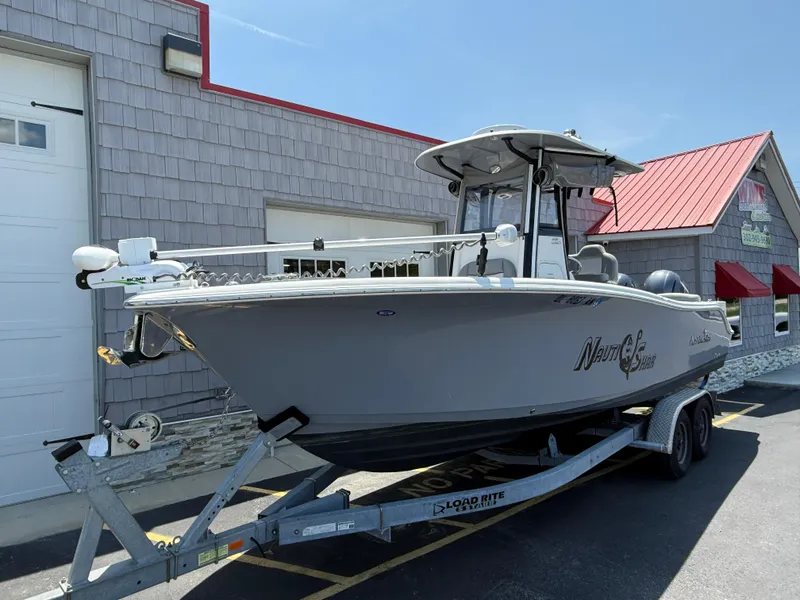 Slide: The Image of 2022 NauticStar 2602 Legacy boat on trailer outside a building. - 3