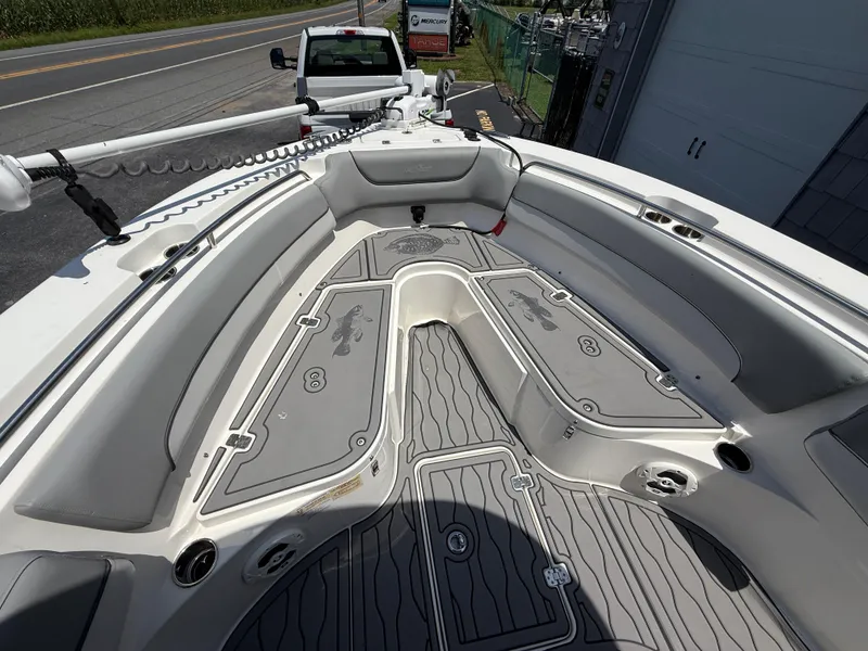 Slide: The Image of 2022 NauticStar 2602 Legacy boat interior with sleek seating and storage compartments. - 30