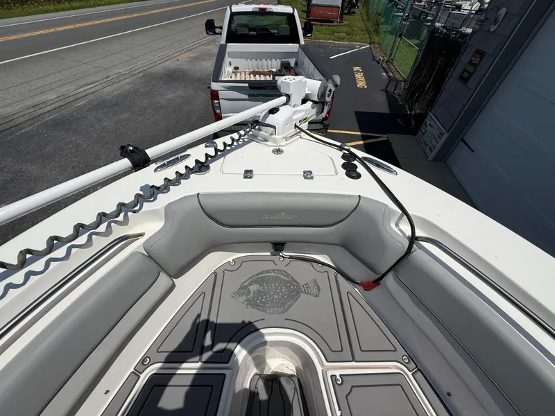 Slide: The Image of 2022 NauticStar 2602 Legacy boat bow with seating and fishing rod holder. - 31
