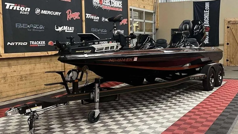 Slide: The Image of 2018 Skeeter ZX250 bass boat on trailer in showroom with branded backdrop. - 3