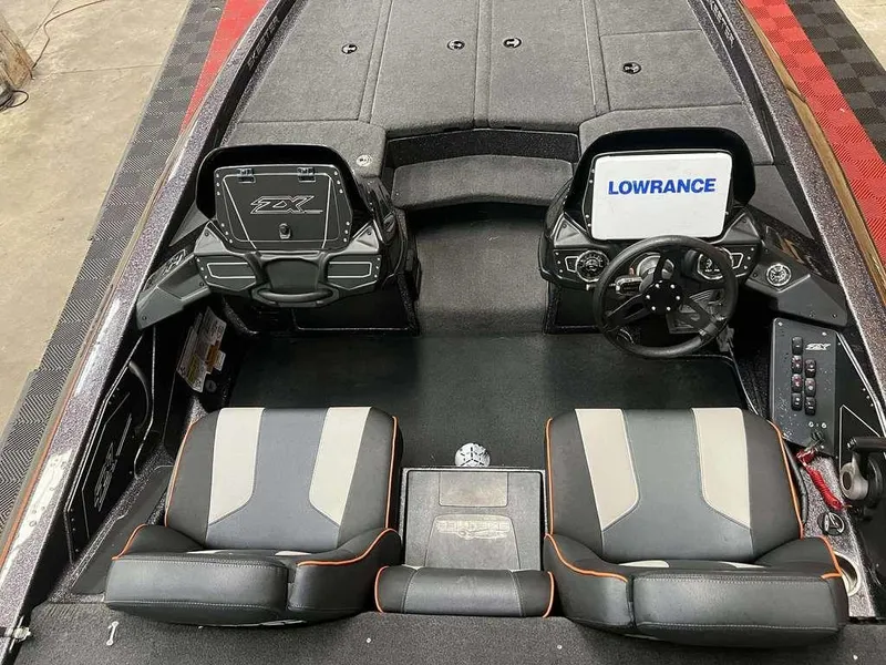 Slide: The Image of 2018 Skeeter ZX250 boat interior with dual seats, steering wheel, and Lowrance display. - 6