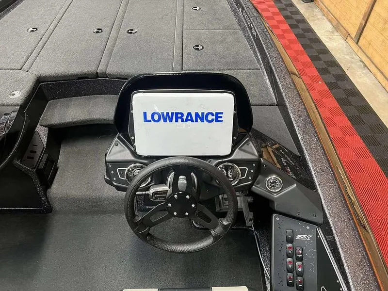 Slide: The Image of 2018 Skeeter ZX250 boat dashboard with Lowrance Elite display and steering wheel. - 7