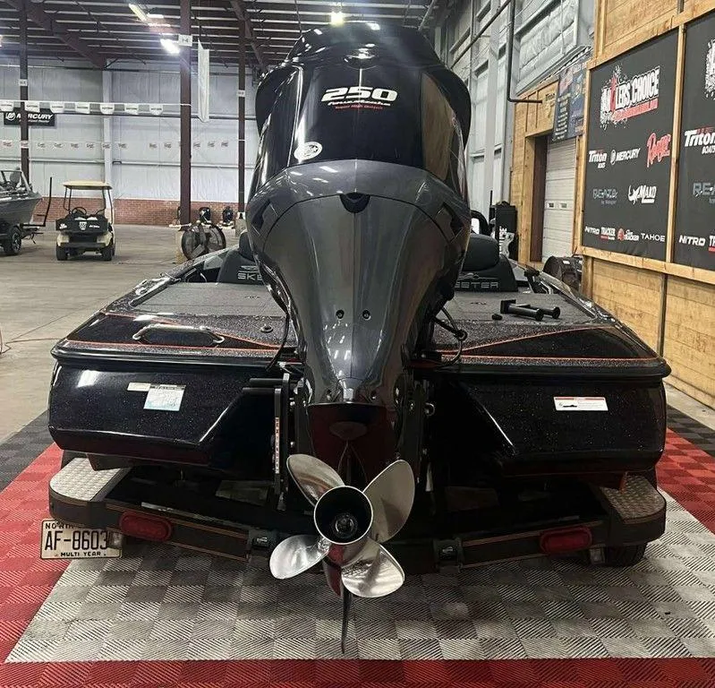 Slide: The Image of 2018 Skeeter ZX250 boat with powerful outboard motor in a showroom setting. - 8
