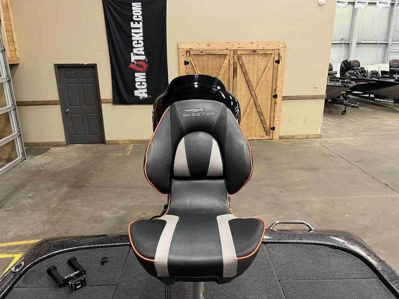 Slide: The Image of 2018 Skeeter ZX250 boat seat in a showroom with ACM Tackle banner. - 9