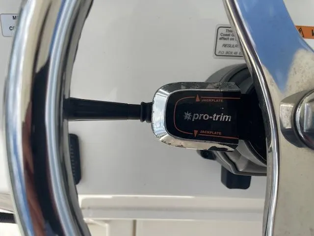 Slide: The Image of Steering wheel and Pro-Trim control on 2021 Regulator 26XO boat. - 16