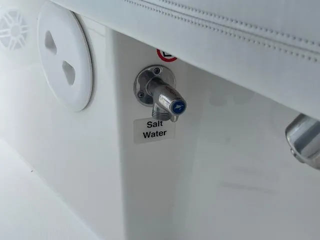 Slide: The Image of Saltwater outlet on 2021 Regulator 26XO boat, featuring a sleek white design. - 17
