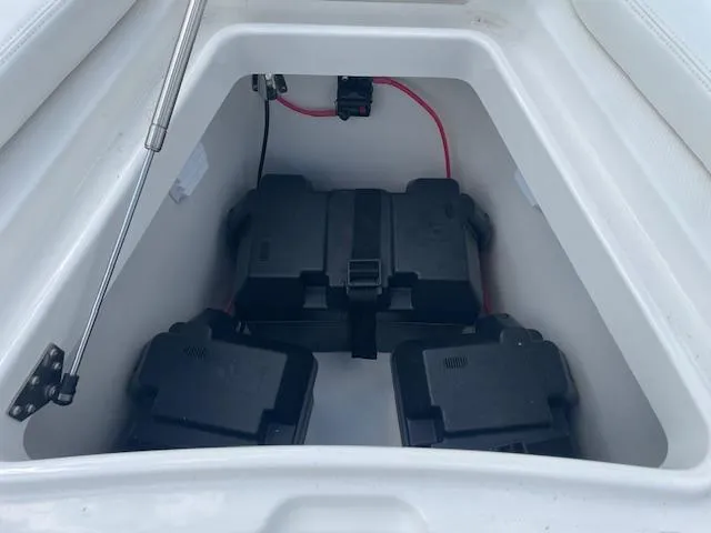 Slide: The Image of Battery compartment of 2021 Regulator 26XO boat, featuring three secured battery boxes. - 19