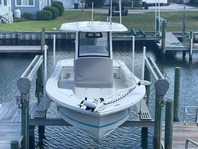 Slide: The Image of 2021 Regulator 26XO boat docked on a lift in a marina. - 2