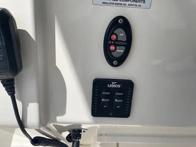 Slide: The Image of Control panel of a 2021 Regulator 26XO boat with Lenco trim tab switches. - 21