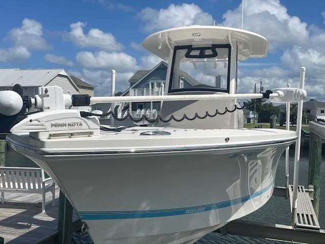Slide: The Image of 2021 Regulator 26XO boat docked under a clear blue sky. - 3