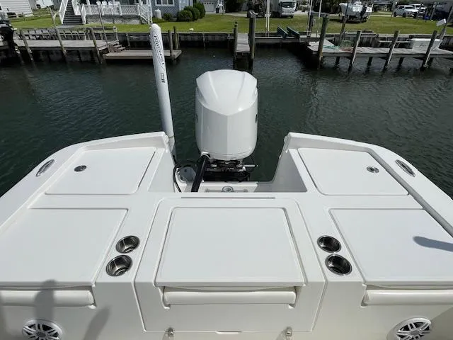 Slide: The Image of 2021 Regulator 26XO boat stern view with outboard motor and rod holders. - 7