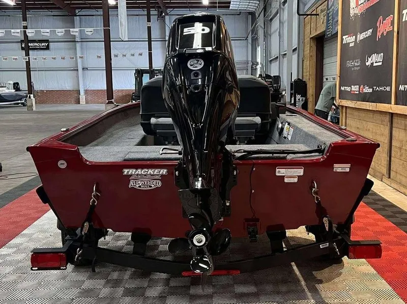 Slide: The Image of 2026 Tracker Super Guide™ V-16 SC boat with powerful outboard motor in showroom. - 4