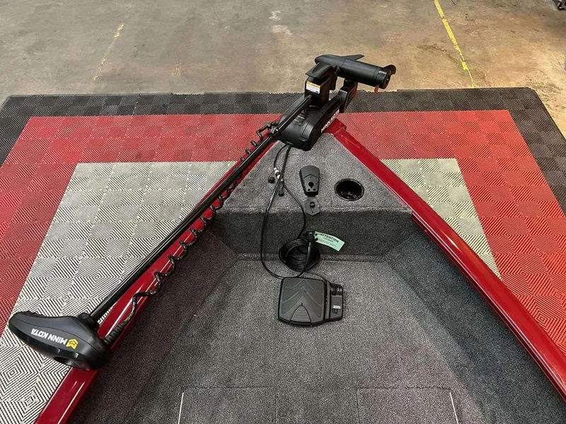 Slide: The Image of 2026 Tracker Super Guide™ V-16 SC boat with Minn Kota trolling motor on red and gray deck. - 6