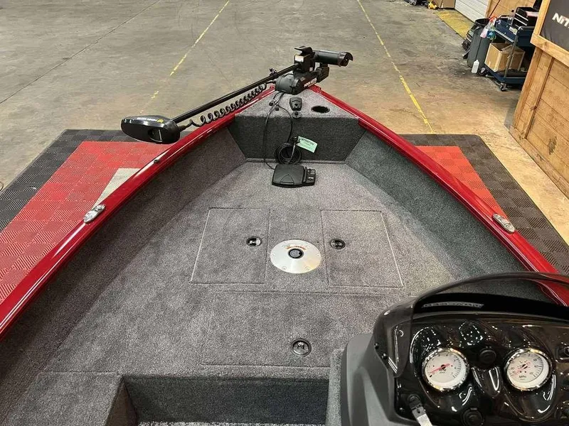 Slide: The Image of 2026 Tracker Super Guide™ V-16 SC boat interior with red trim and control panel. - 7