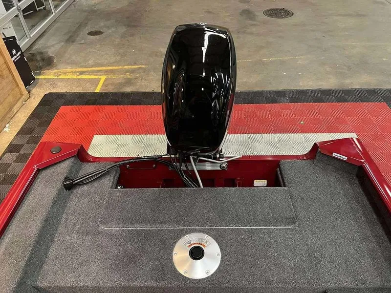 Slide: The Image of 2026 Tracker Super Guide™ V-16 SC boat with outboard motor in a showroom. - 8