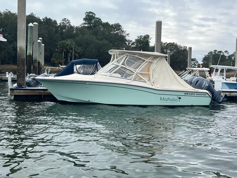 Slide: The Image of 2021 Grady-White Freedom 255 boat docked at marina with canopy cover. - 16