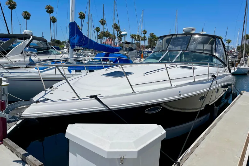 Slide: The Image of 2005 Chaparral Signature 350 yacht docked at marina with palm trees in background. - 1
