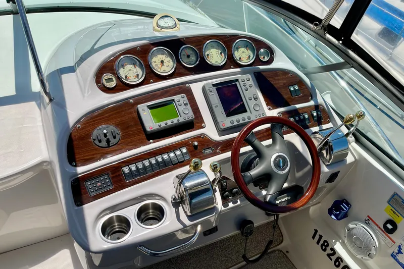 Slide: The Image of Cockpit of 2005 Chaparral Signature 350 boat with steering wheel and navigation controls. - 13