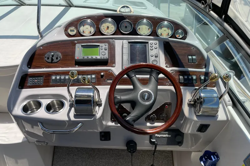 Slide: The Image of 2005 Chaparral Signature 350 boat dashboard with gauges, controls, and steering wheel. - 14