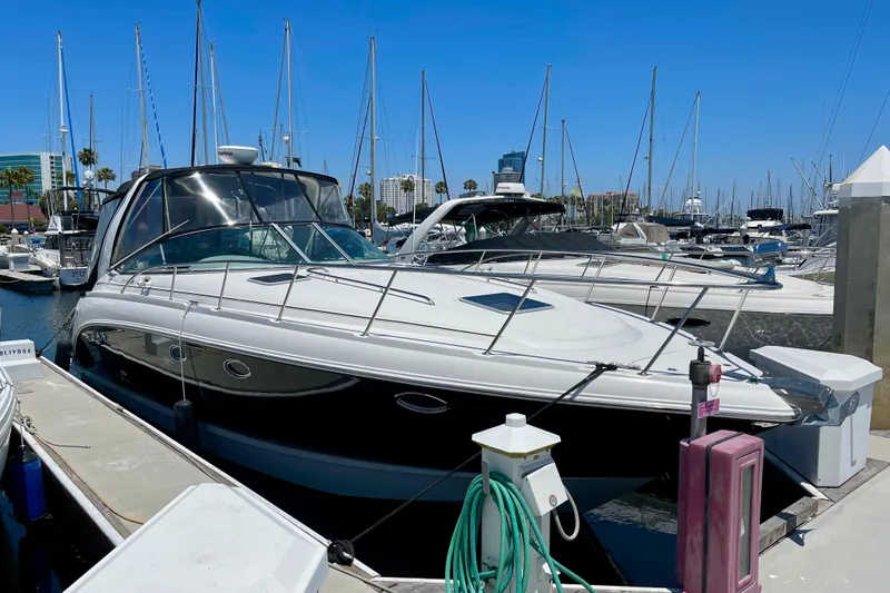 Slide: The Image of 2005 Chaparral Signature 350 yacht docked at a marina under clear blue skies. - 2
