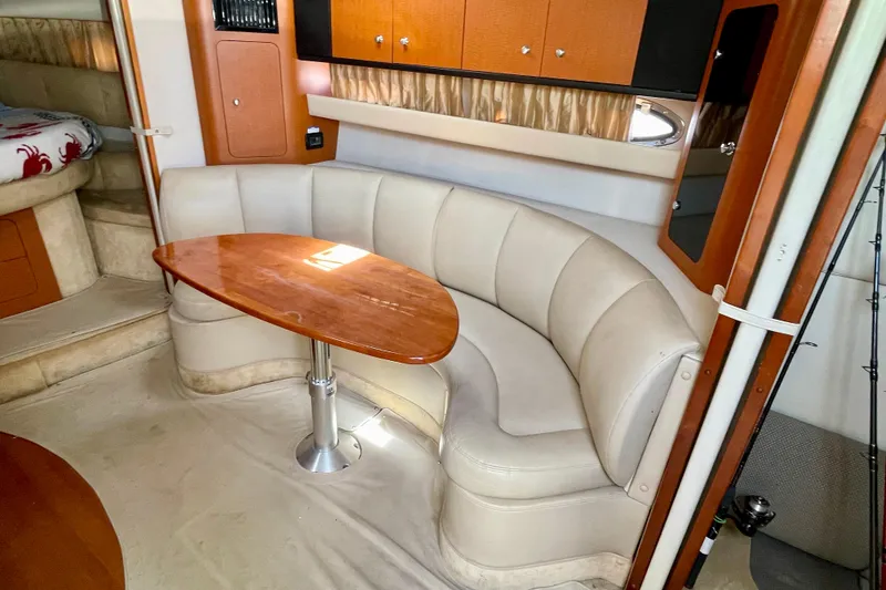 Slide: The Image of 2005 Chaparral Signature 350 interior with curved seating and wooden table. - 22