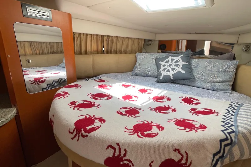 Slide: The Image of Cozy cabin interior of 2005 Chaparral Signature 350 with nautical-themed bedding. - 27