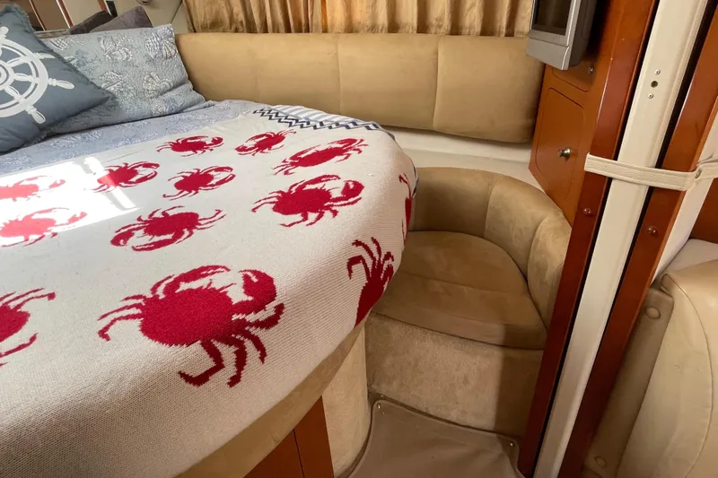 Slide: The Image of 2005 Chaparral Signature 350 cabin with crab-patterned blanket and nautical-themed decor. - 29