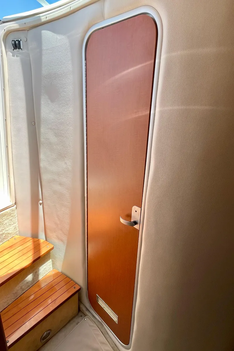 Slide: The Image of Interior of 2005 Chaparral Signature 350 boat with wooden door and steps. - 32