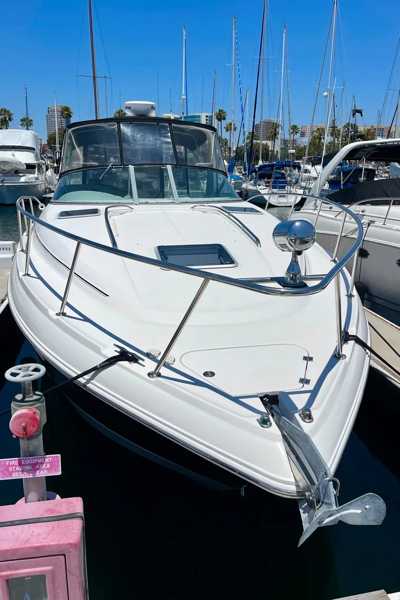 Slide: The Image of 2005 Chaparral Signature 350 yacht docked in marina, clear blue sky background. - 4