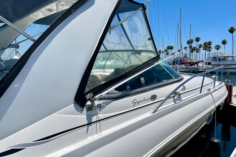 Slide: The Image of 2005 Chaparral Signature 350 boat docked at marina with clear blue sky. - 6